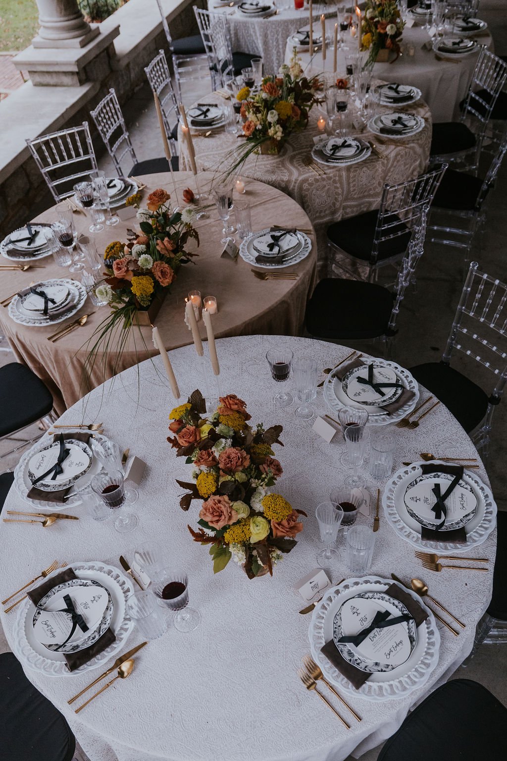 Elegantly set round tables with autumn florals at a Peterson-Dumesnil House wedding reception