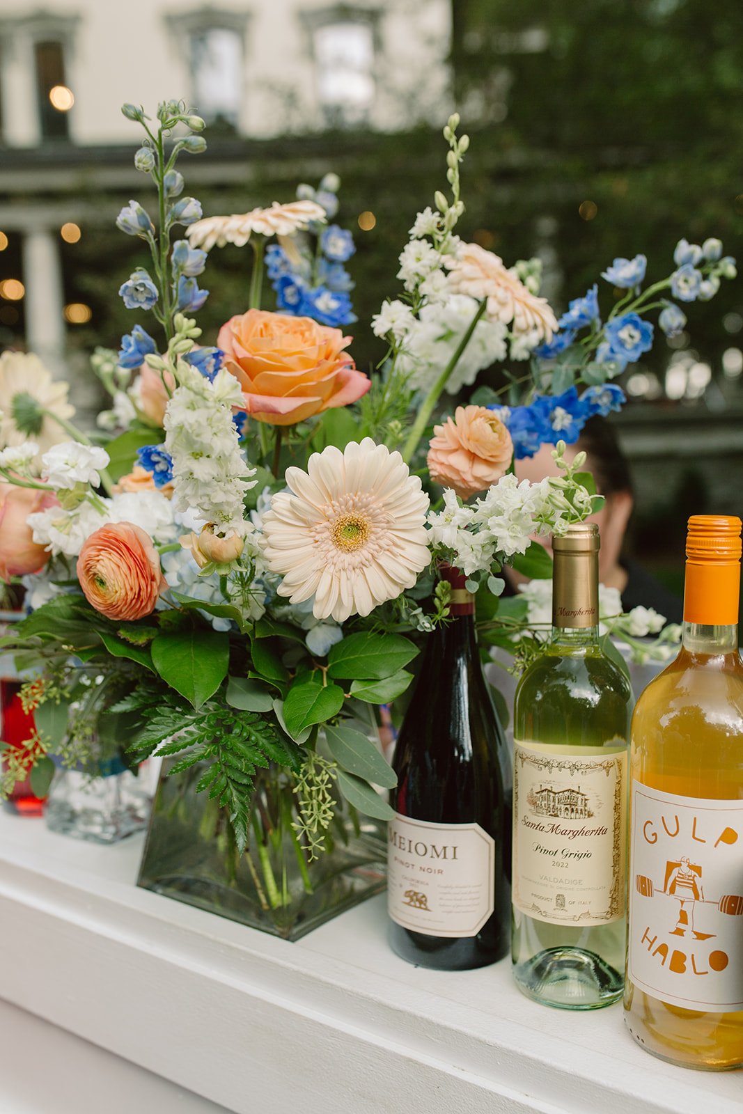 Wine bottles with colorful floral arrangement